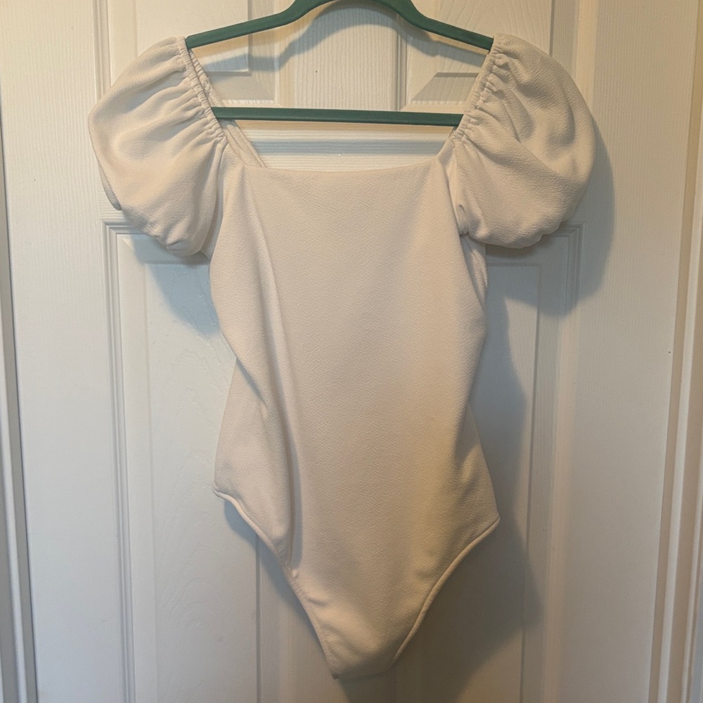 Show Me Your Mumu Pink Label on Cream Garment